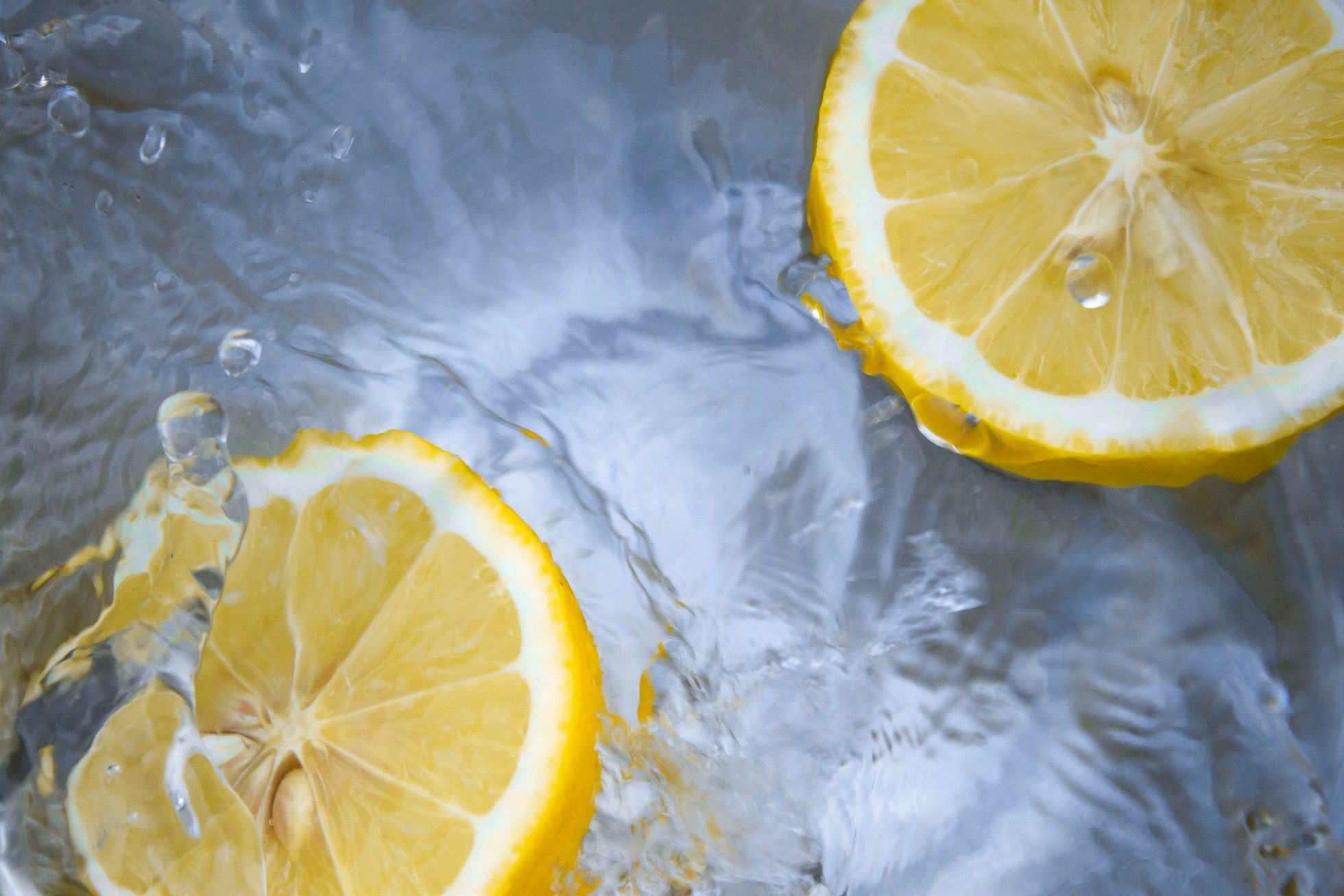 Two lemon slices in swirling water.