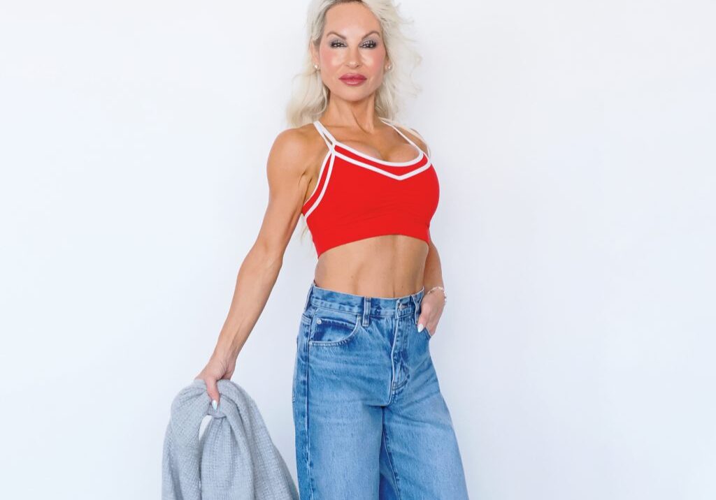 Blonde woman in red crop top, jeans